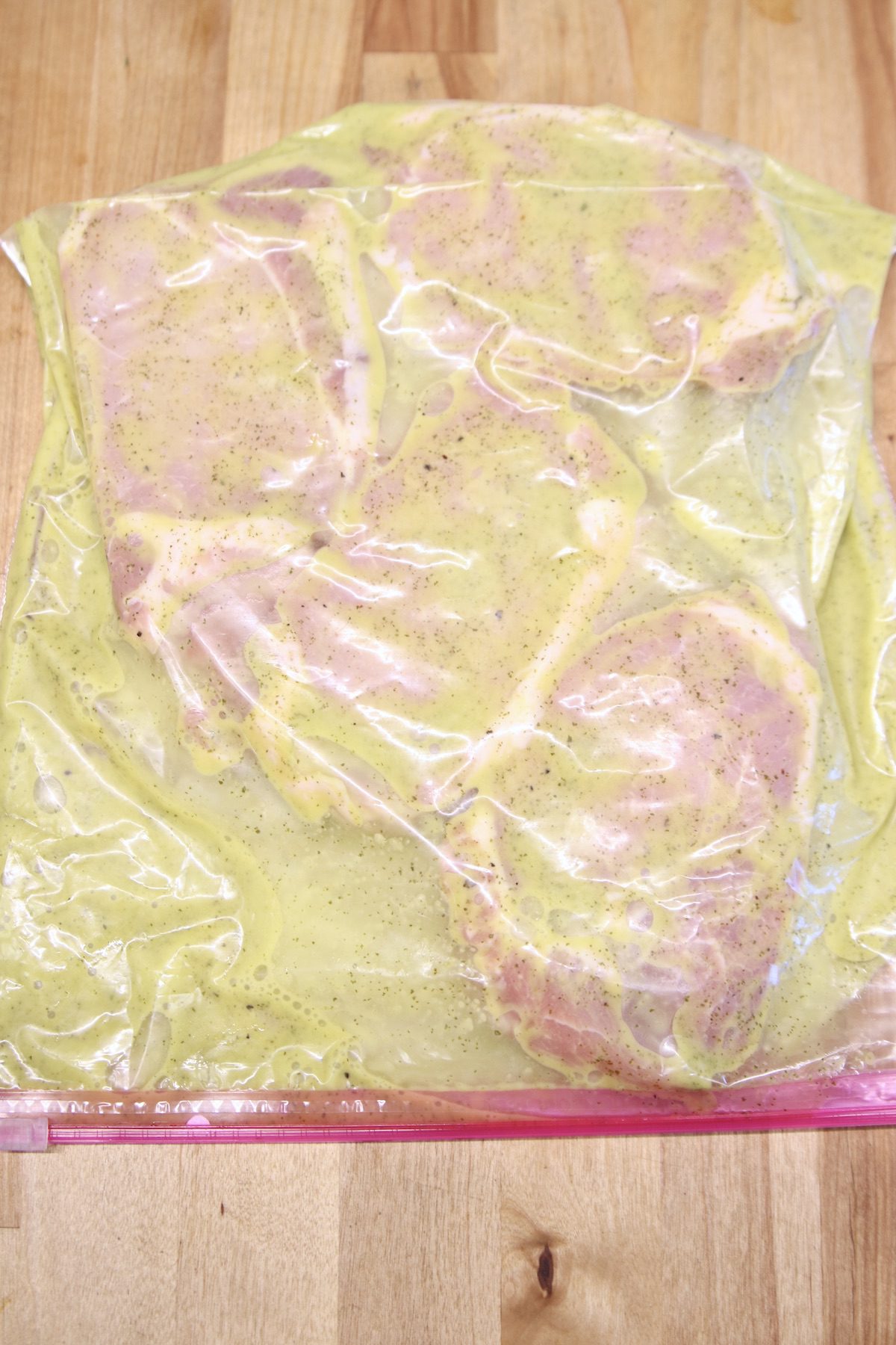 baggie with pork chops and cilantro lime marinade