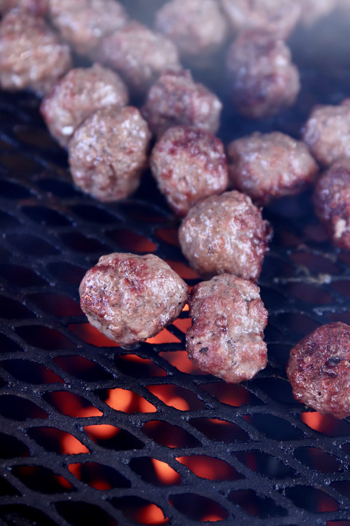 grilled meatballs with grill fire below grate