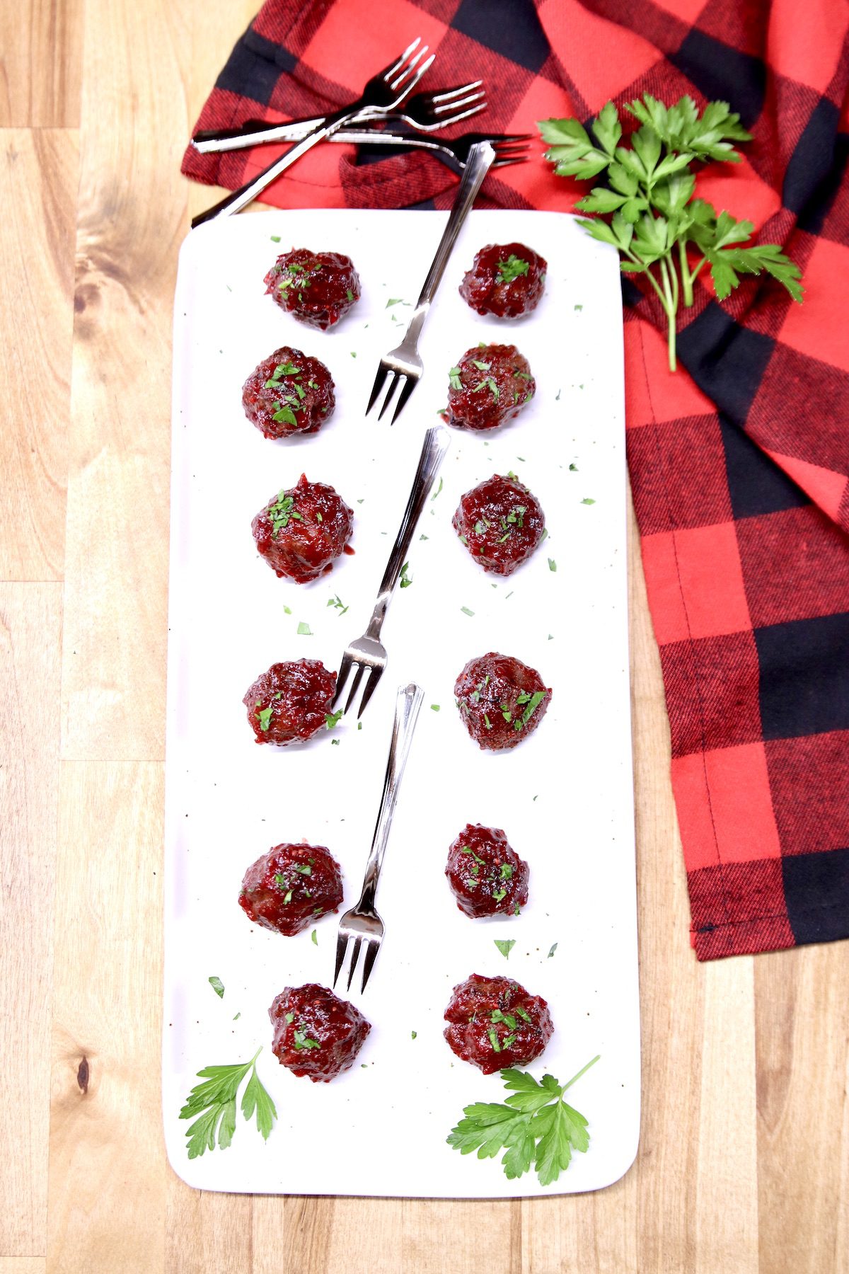 platter of grilled cranberry meatballs with red buffalo check napkin