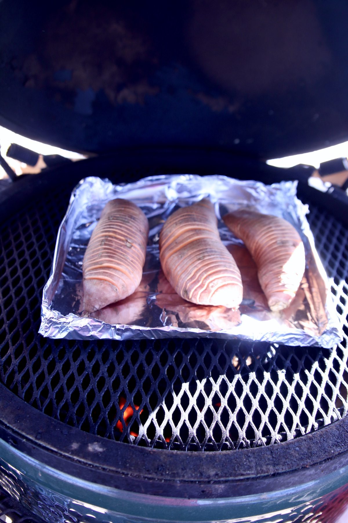 4 hasselback sweet potatoes on the grill