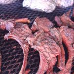marinated venison chops on a grill