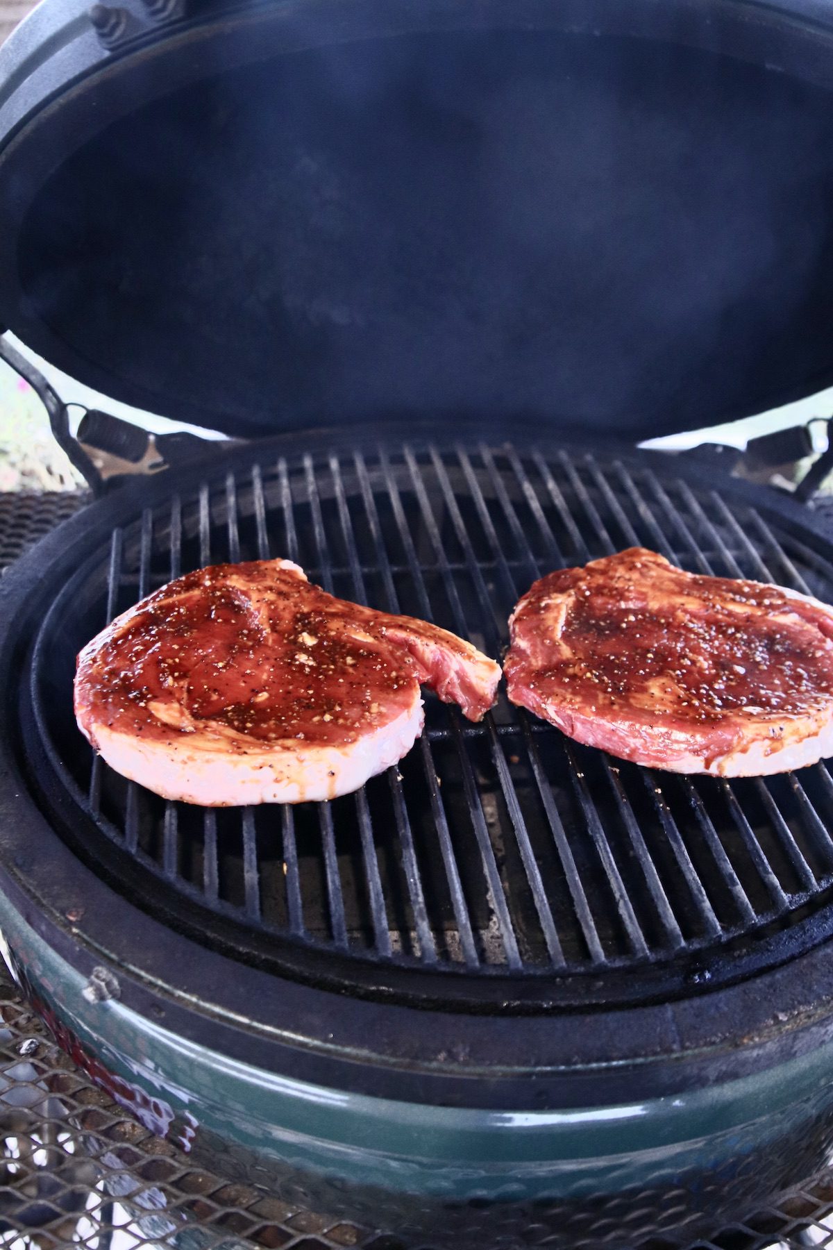 2 ribeye steaks on a grill