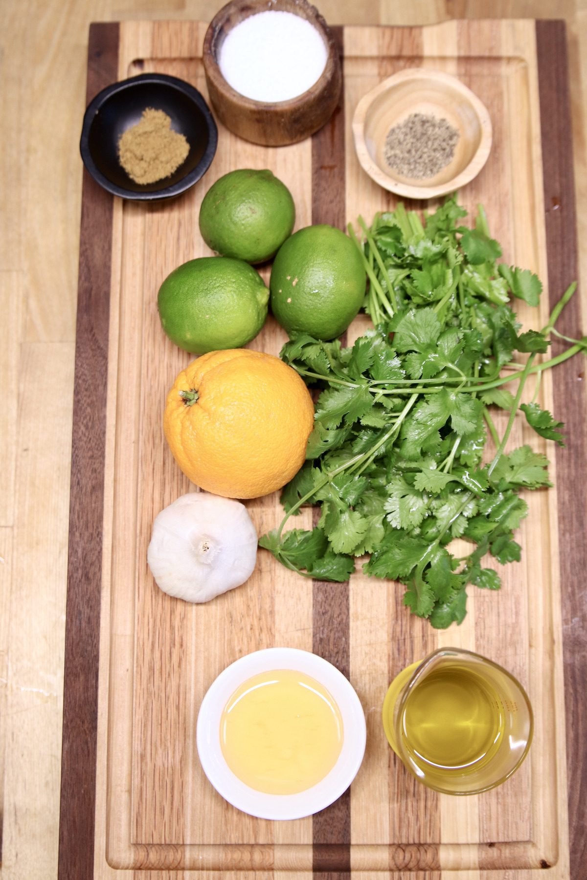 ingredients for cilantro lime marinade on a wood cutting board