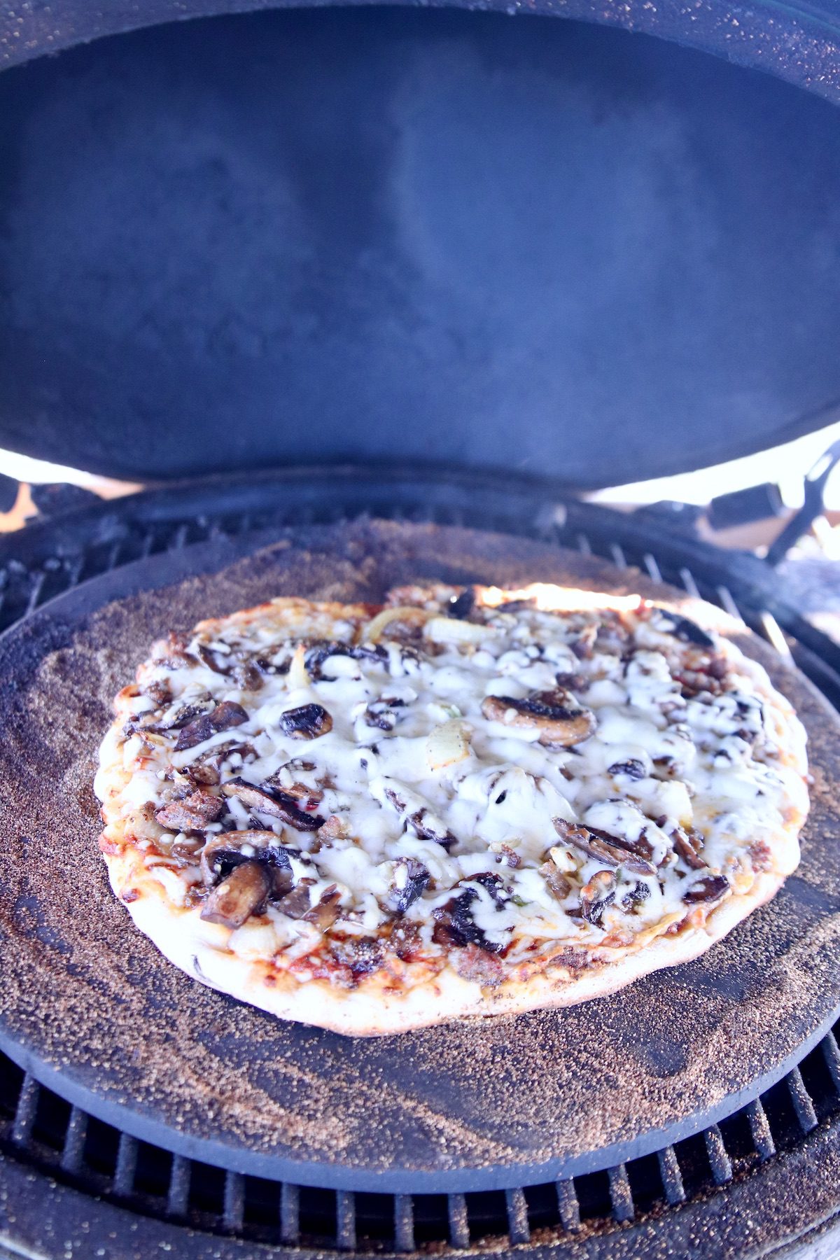 pizza cooking on a grill