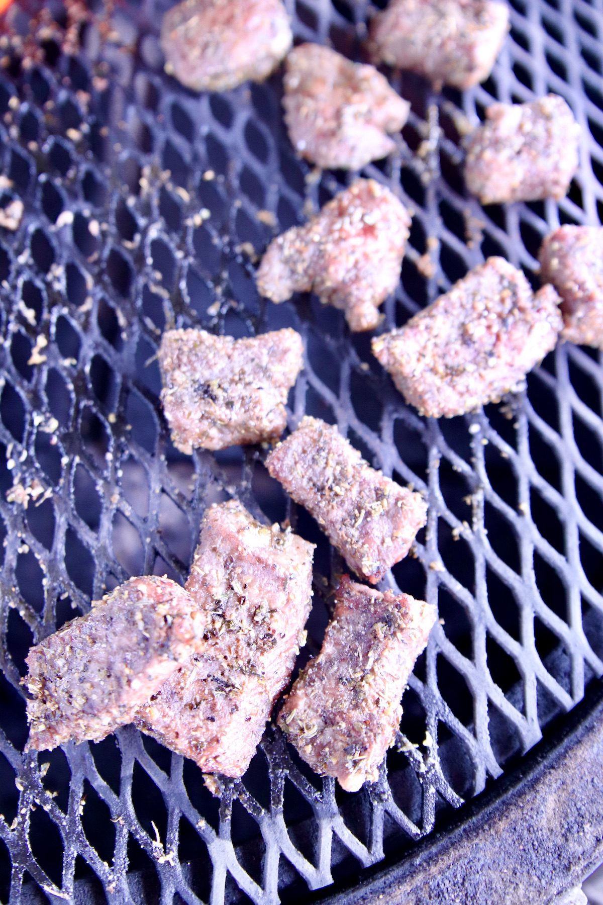 closeup of steak bites on grill