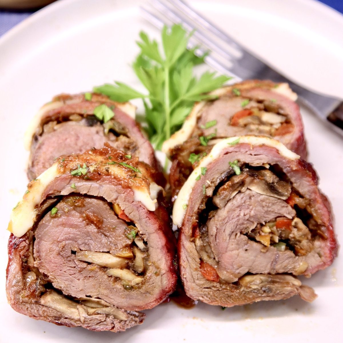 grilled stuffed steak slices on a plate