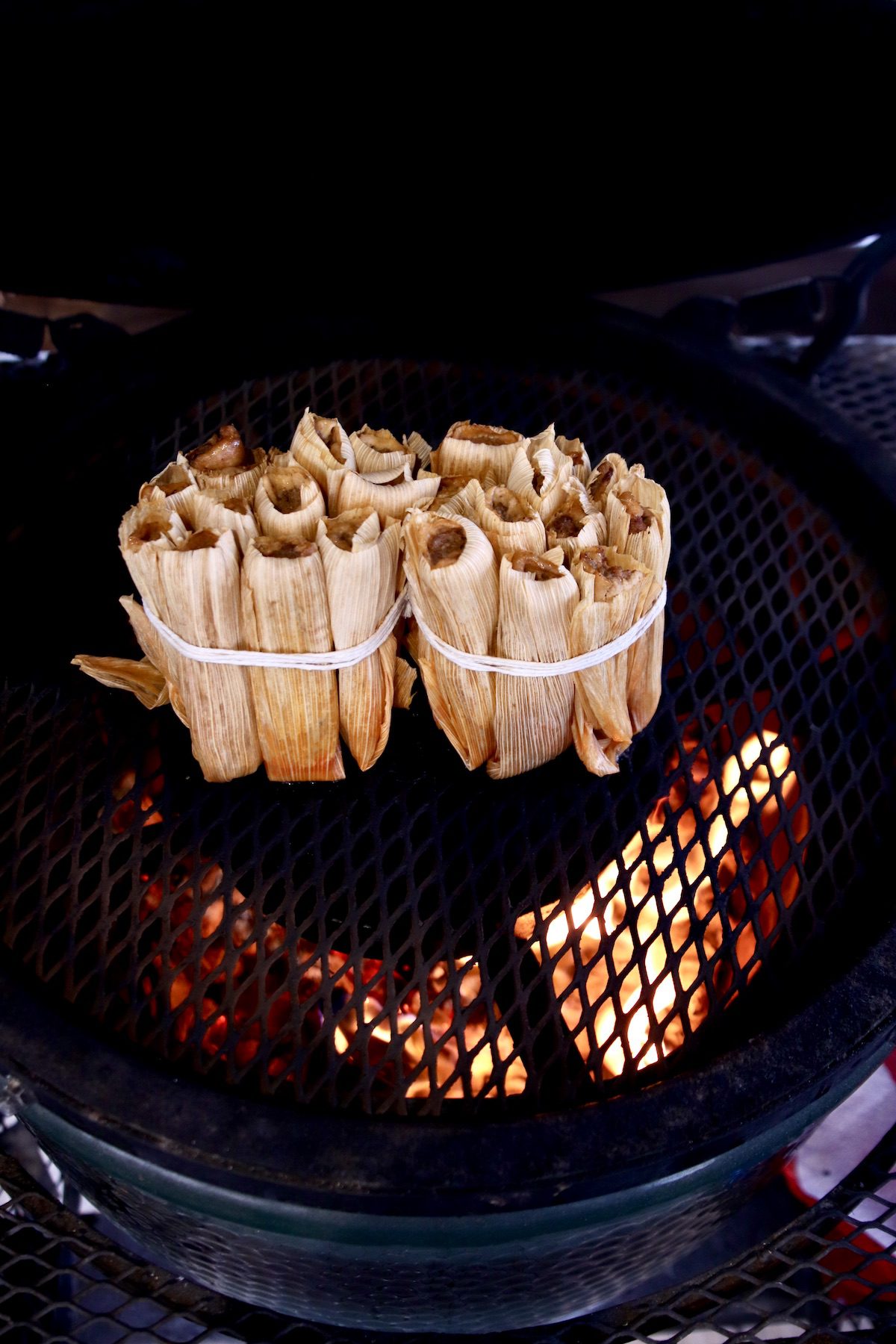 2 bundles of tamales on a grill
