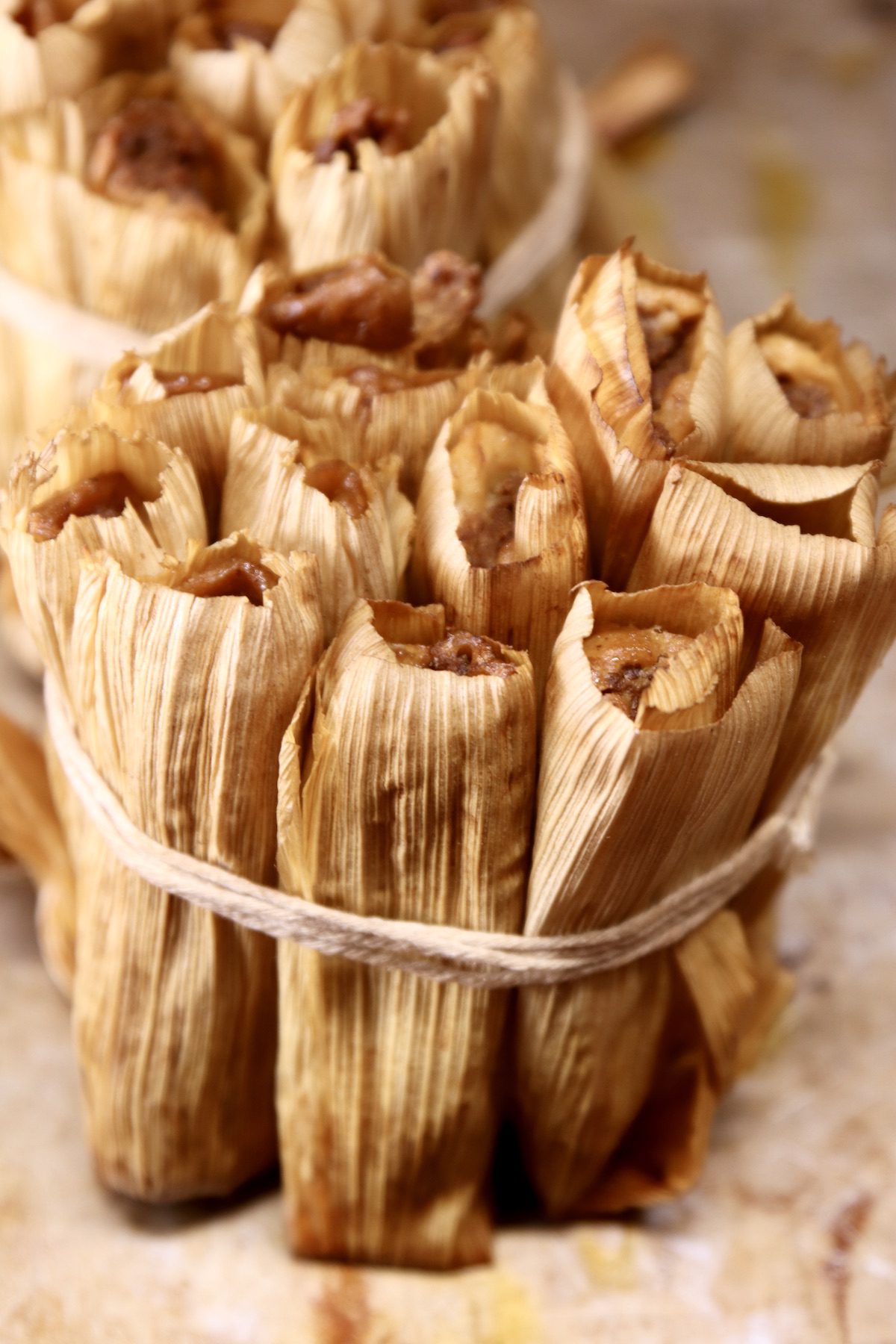 grilled tamales in a bundle on a sheet pan