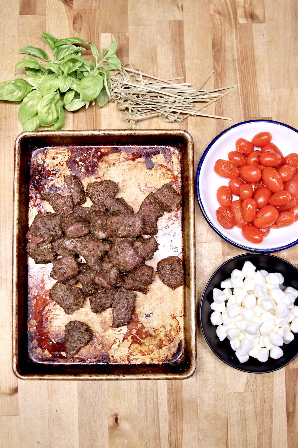 basil, grilled steak bites, grape tomatoes, mozzarella pearls