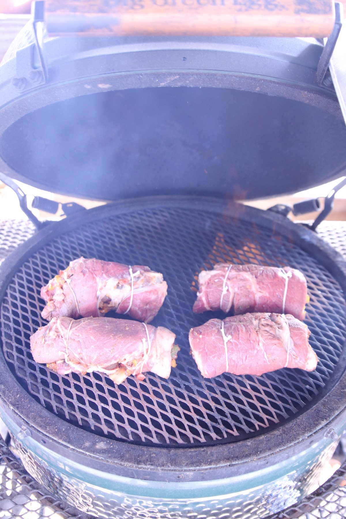 4 rolled steaks on a grill
