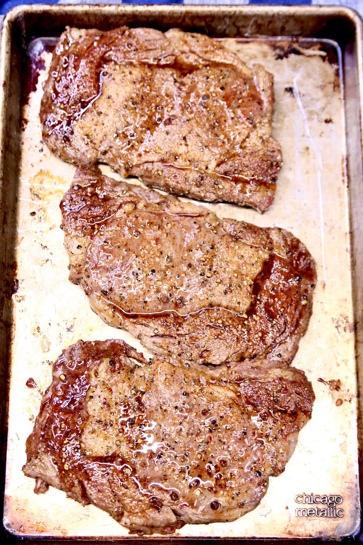 grilled steaks on a sheet pan