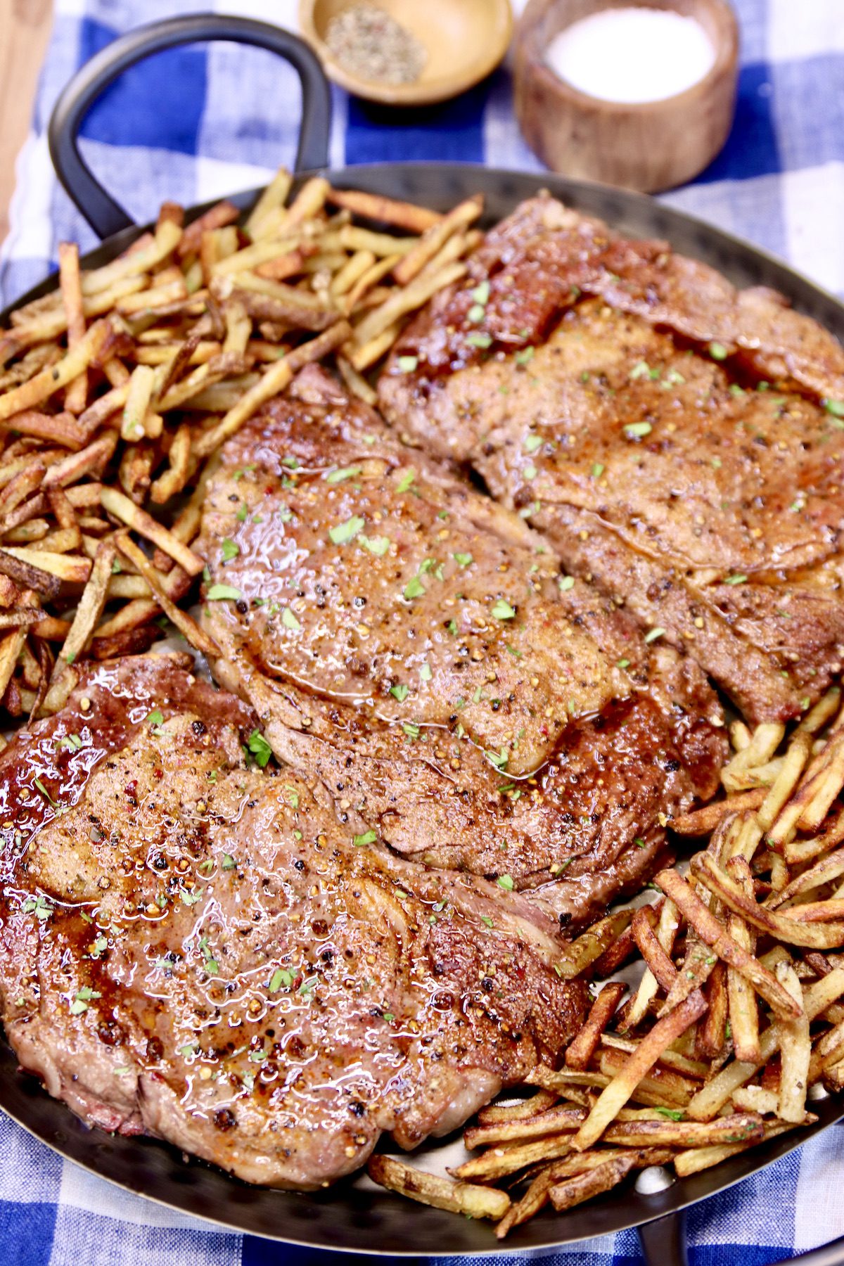 platter of 3 ribeye steaks with fries
