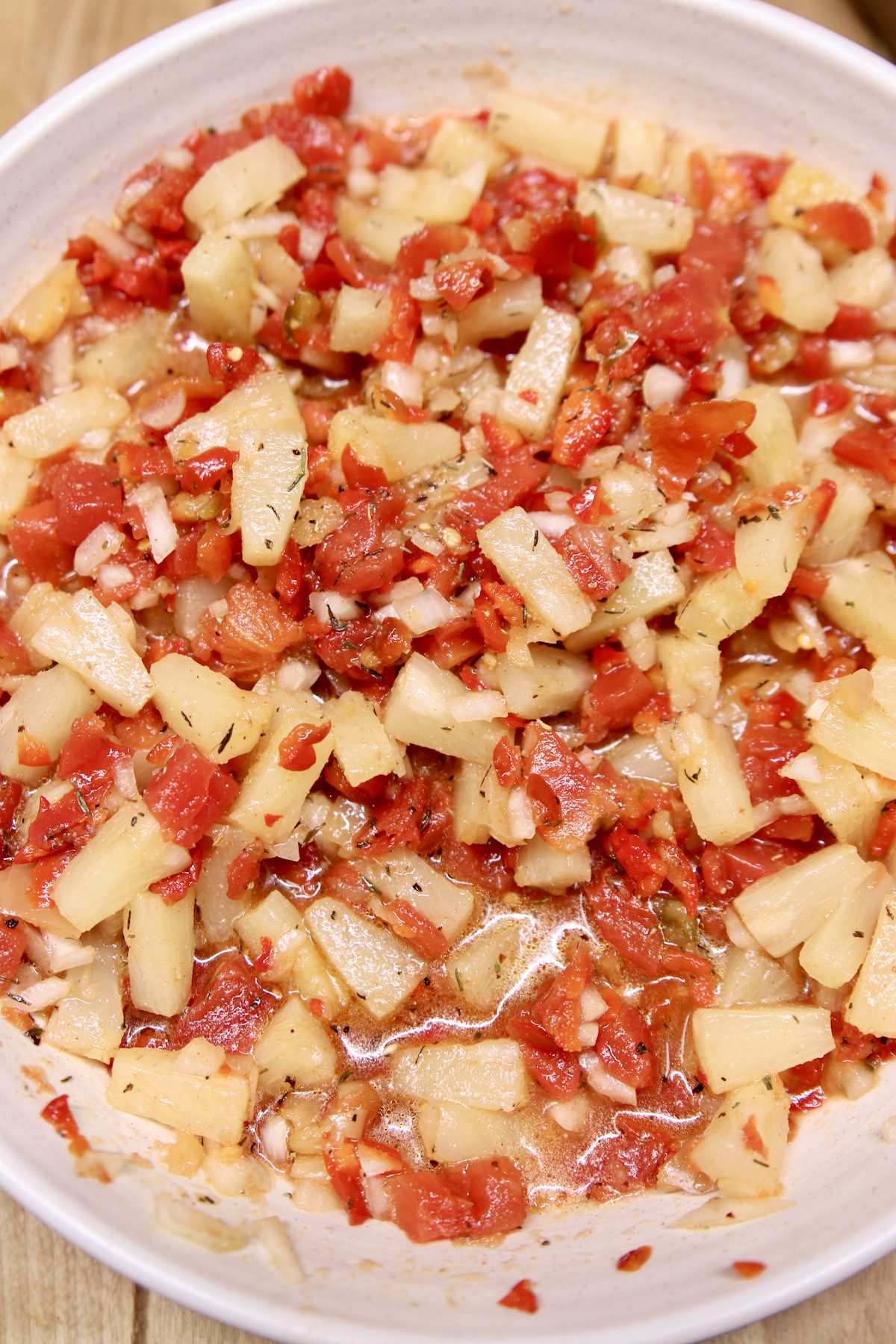 pineapple salsa with tomatoes in a bowl
