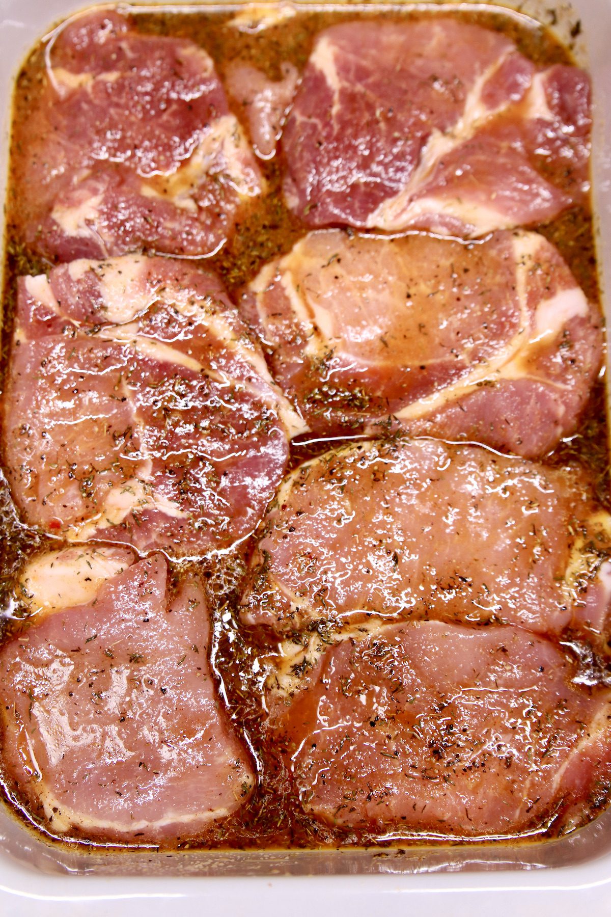 marinating pork chops in a pan