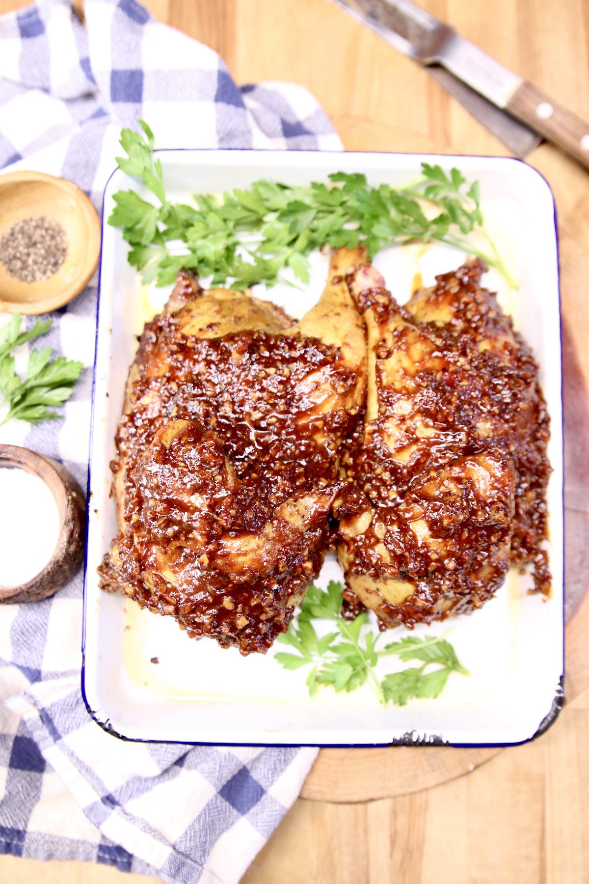 bbq chicken halves on a platter with parsley
