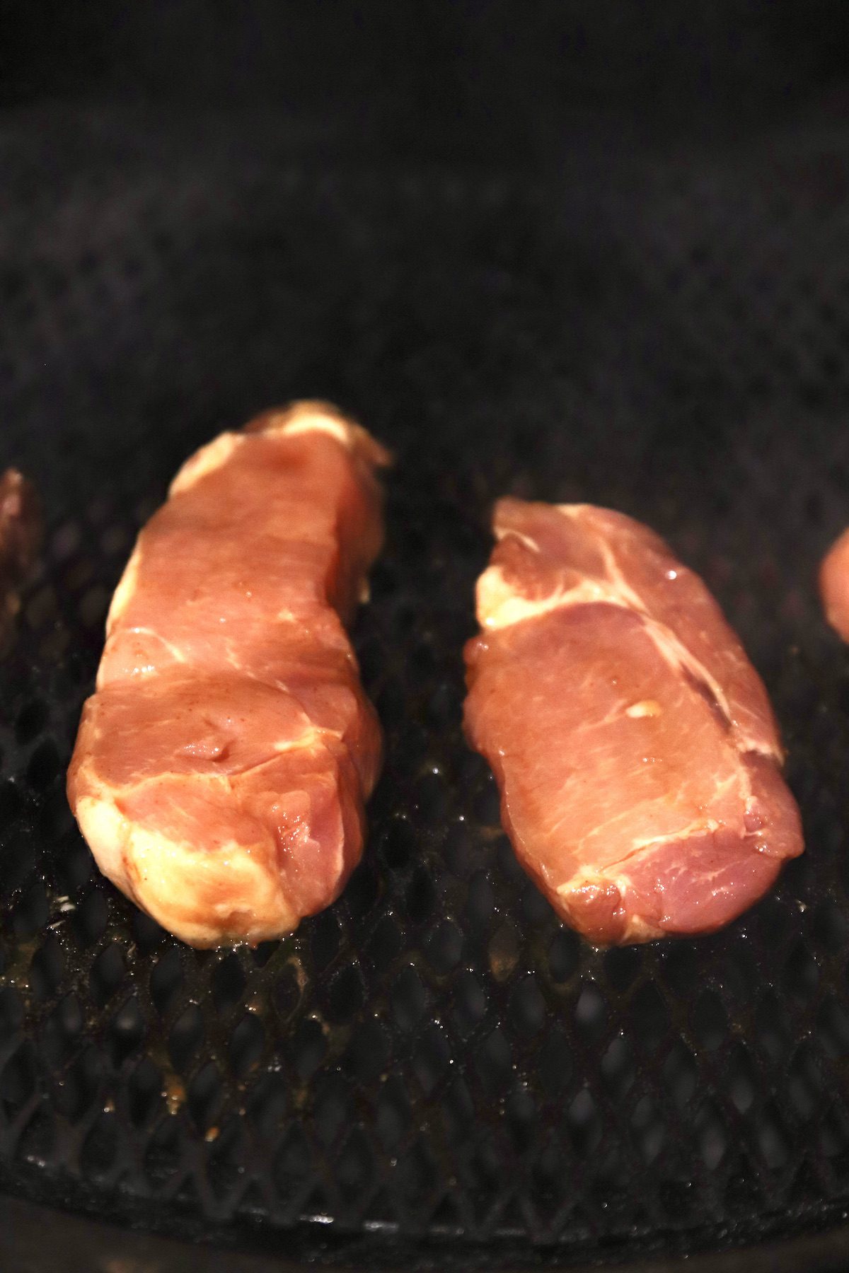 pork chops on a grill.