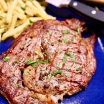 Grilled Steak with fries on a plate. Text overlay.