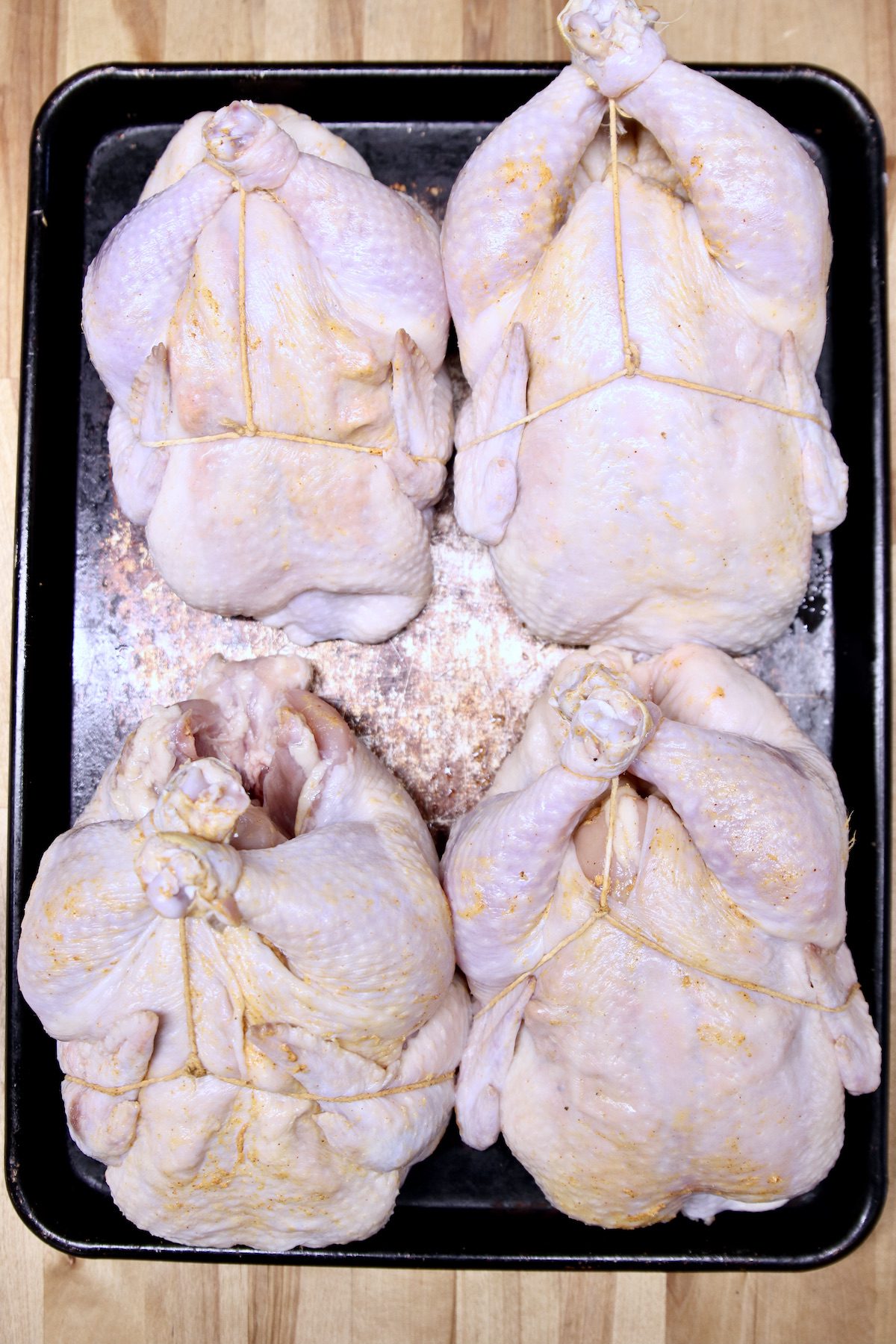 4 whole chickens trussed for grilling