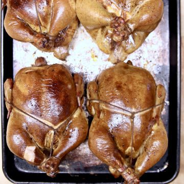 whole grilled chickens on a sheet pan