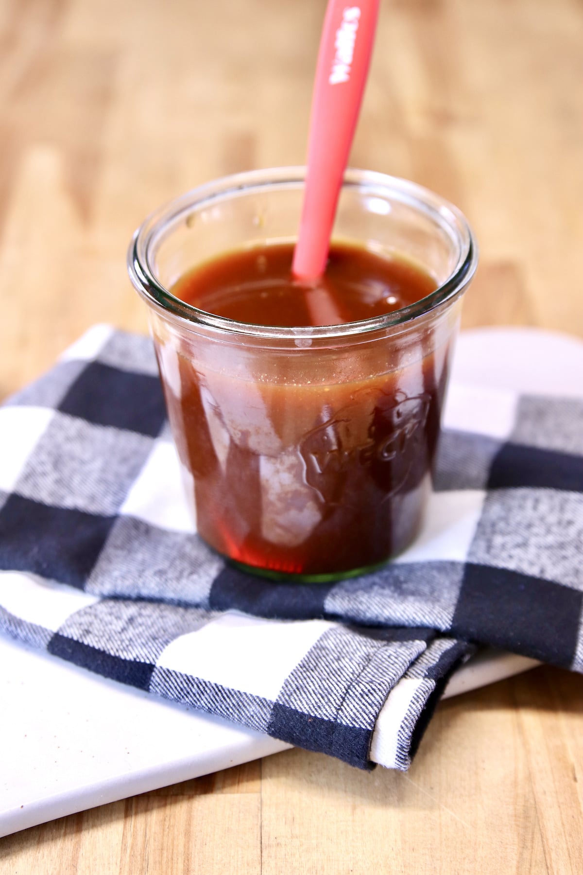BBQ Mop Sauce in a jar with a brush.