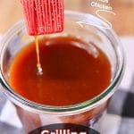 Grilling Mop Sauce in a jar with grill brush, dipping. Text Overlay.