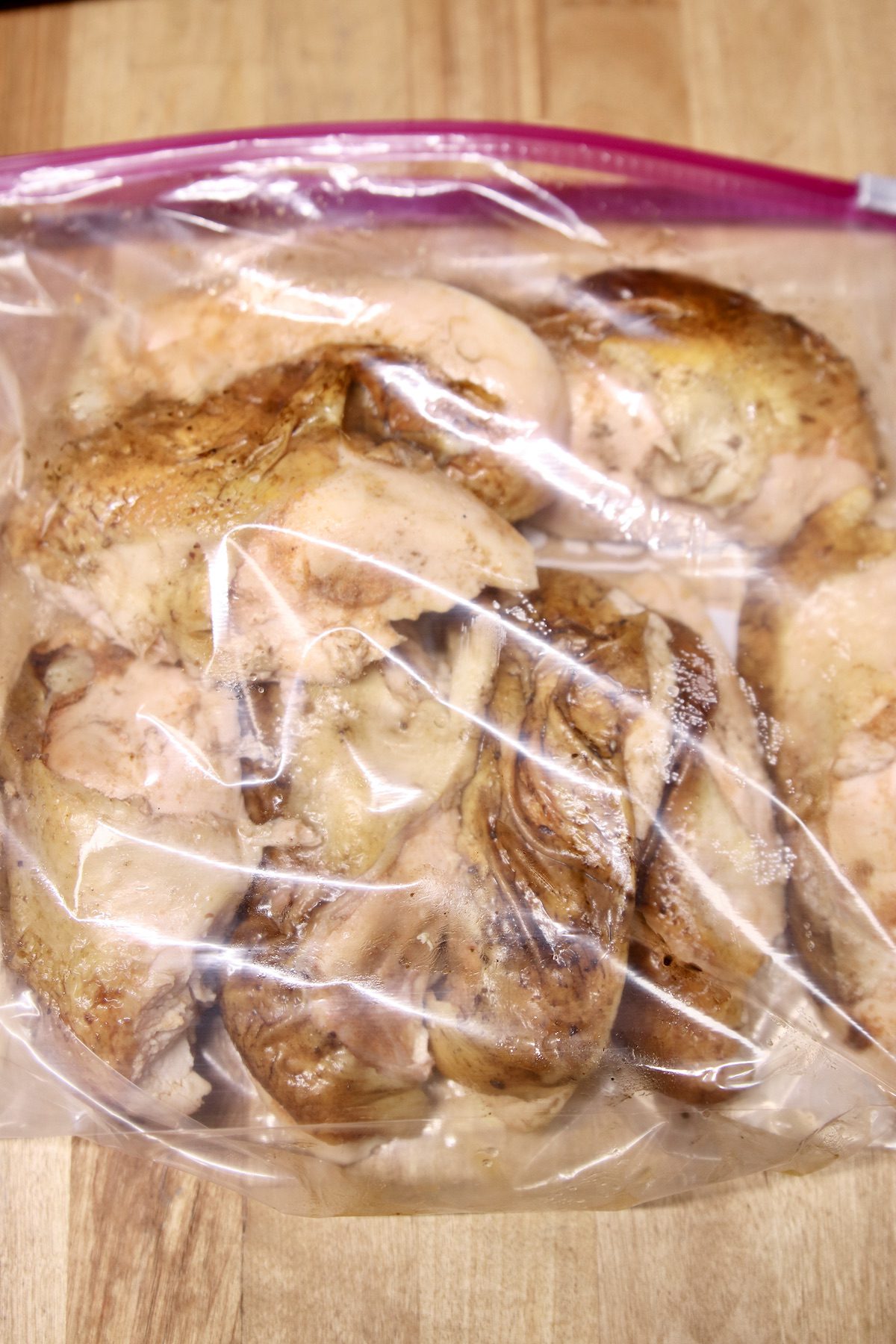 zip top bag with grilled chicken breasts