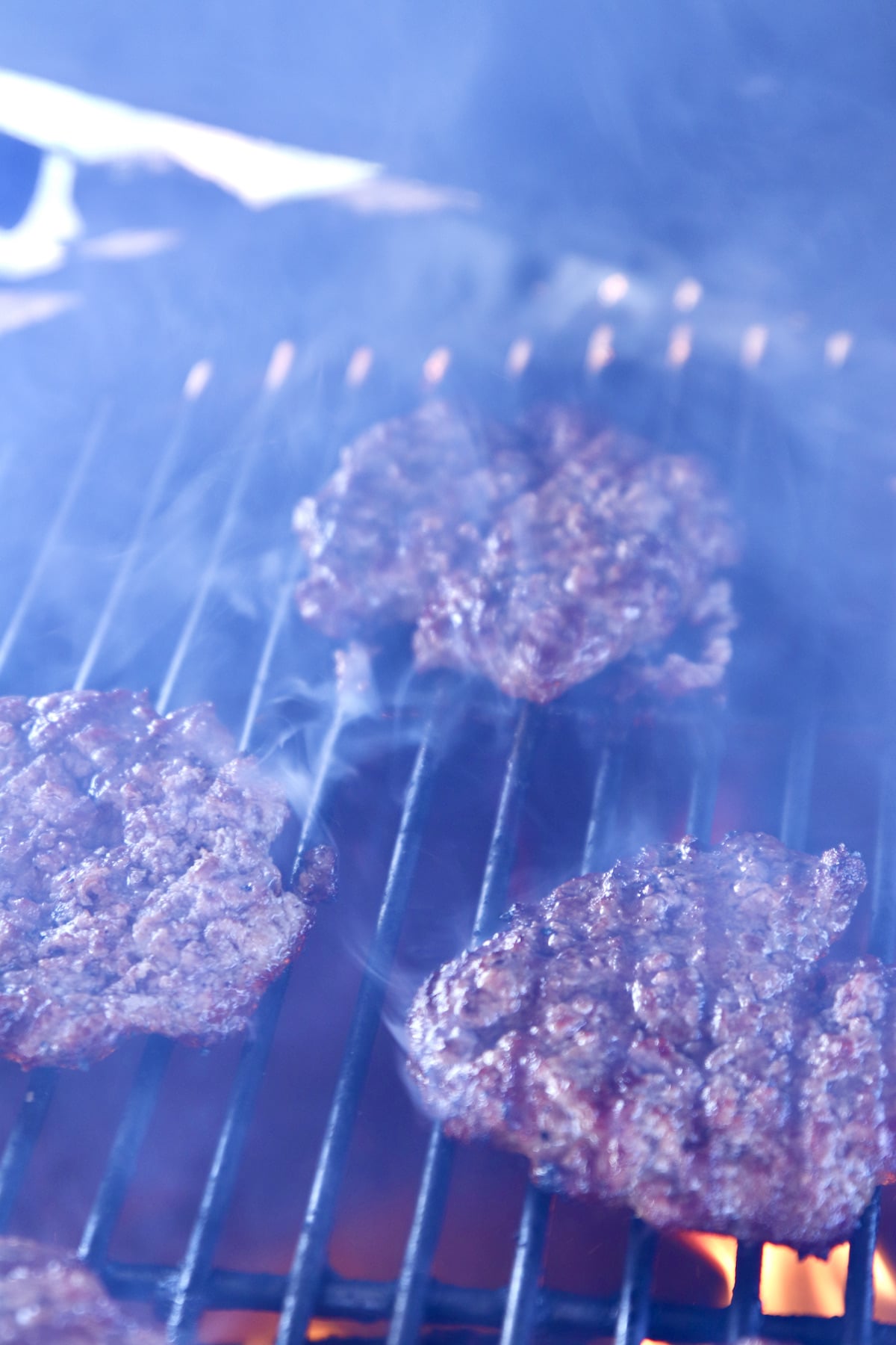 Smoky burgers on grill.