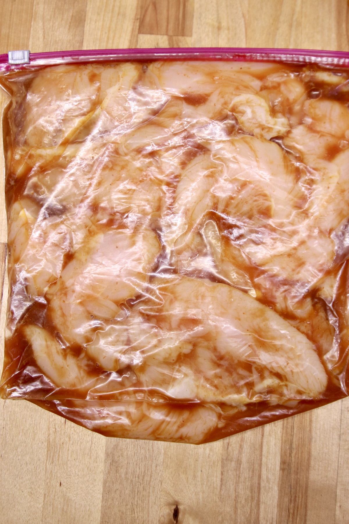 ziploc bag with marinating chicken tenders.