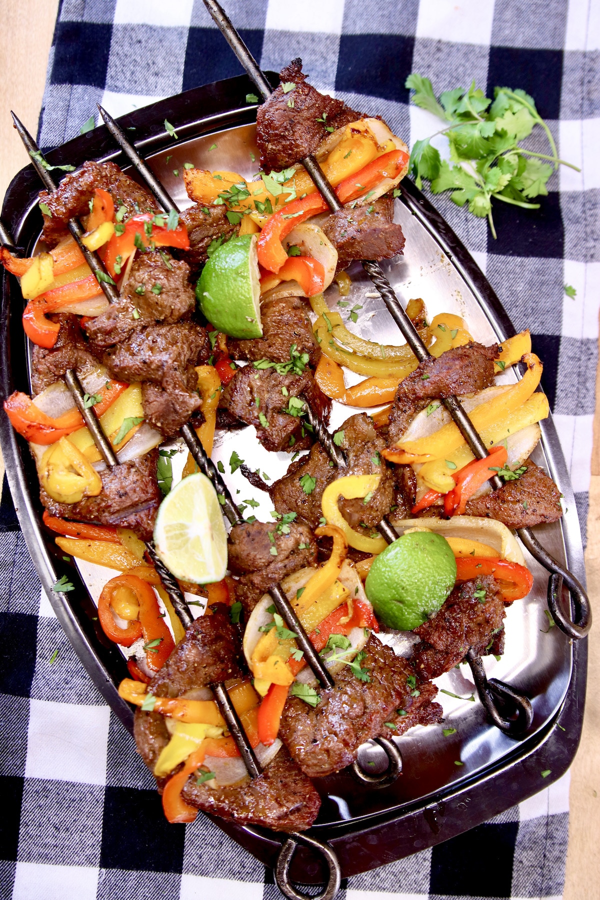platter of grilled steak and peppers.