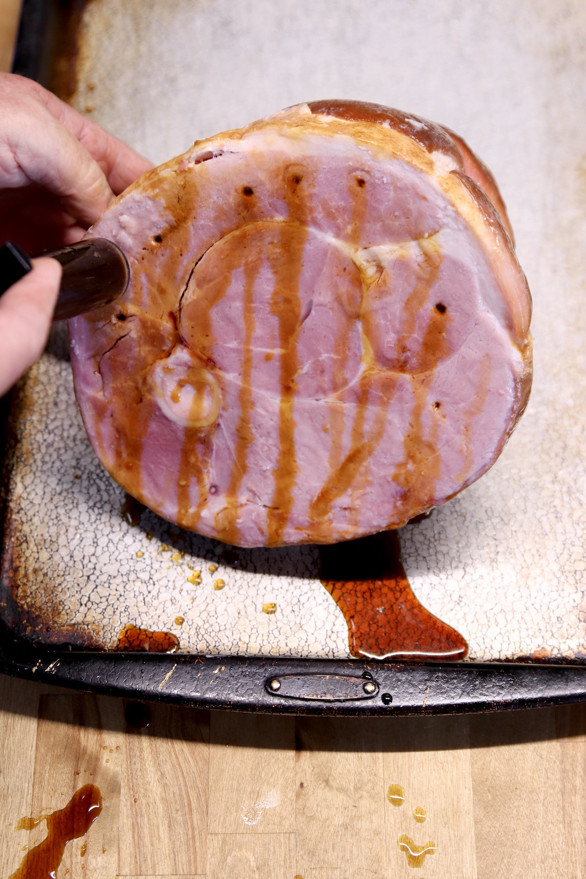 Injecting syrup into ham.