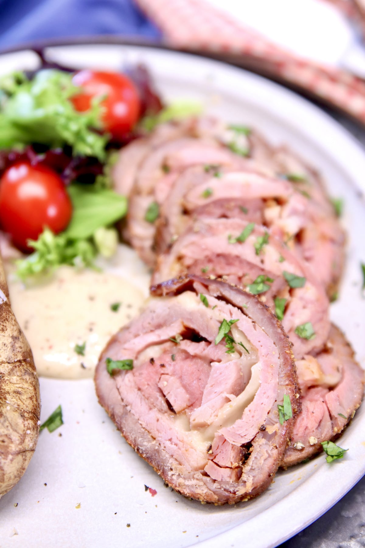 Plate of beef cordon bleu slices with salad.