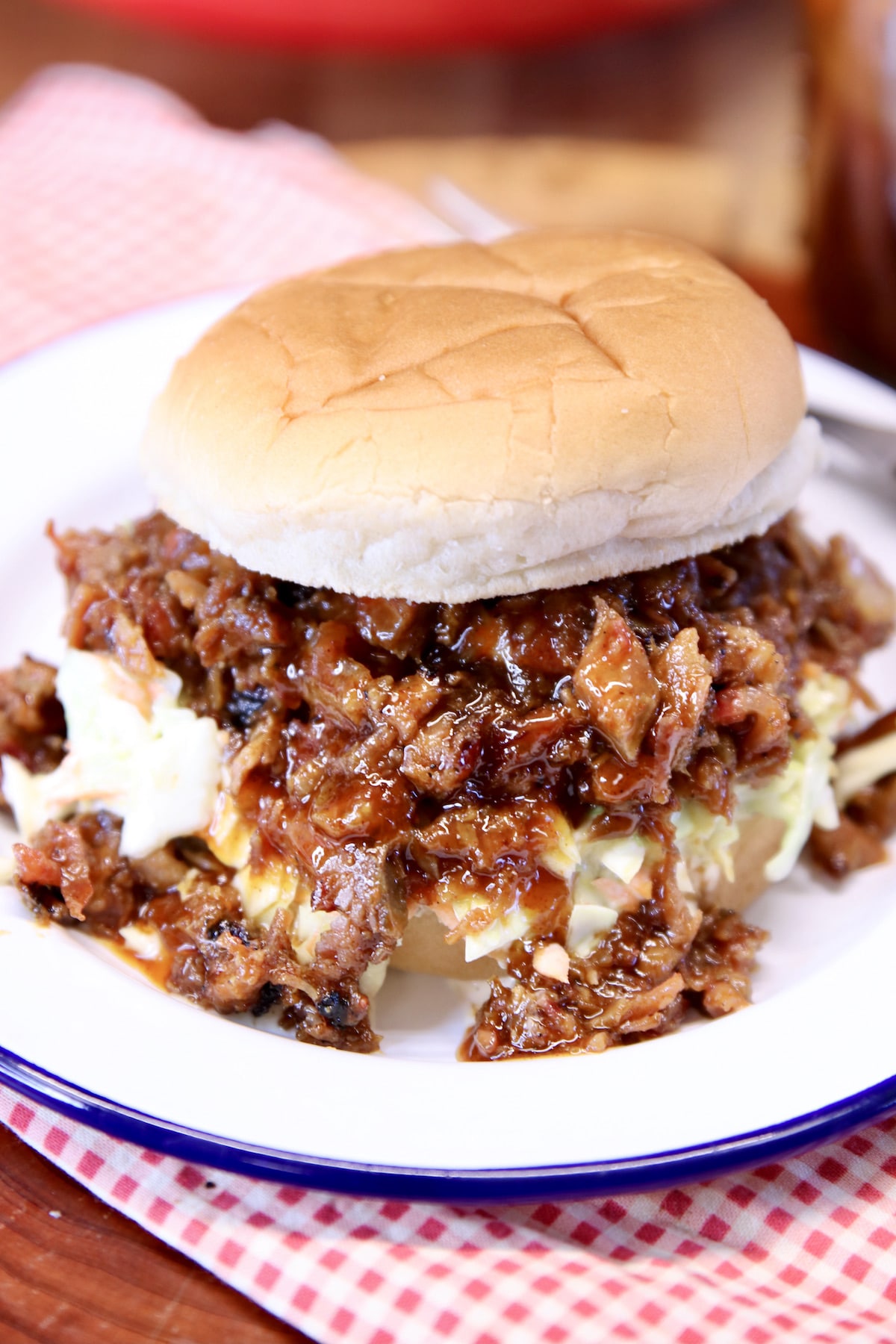 BBQ sandwich with slaw on a plate.