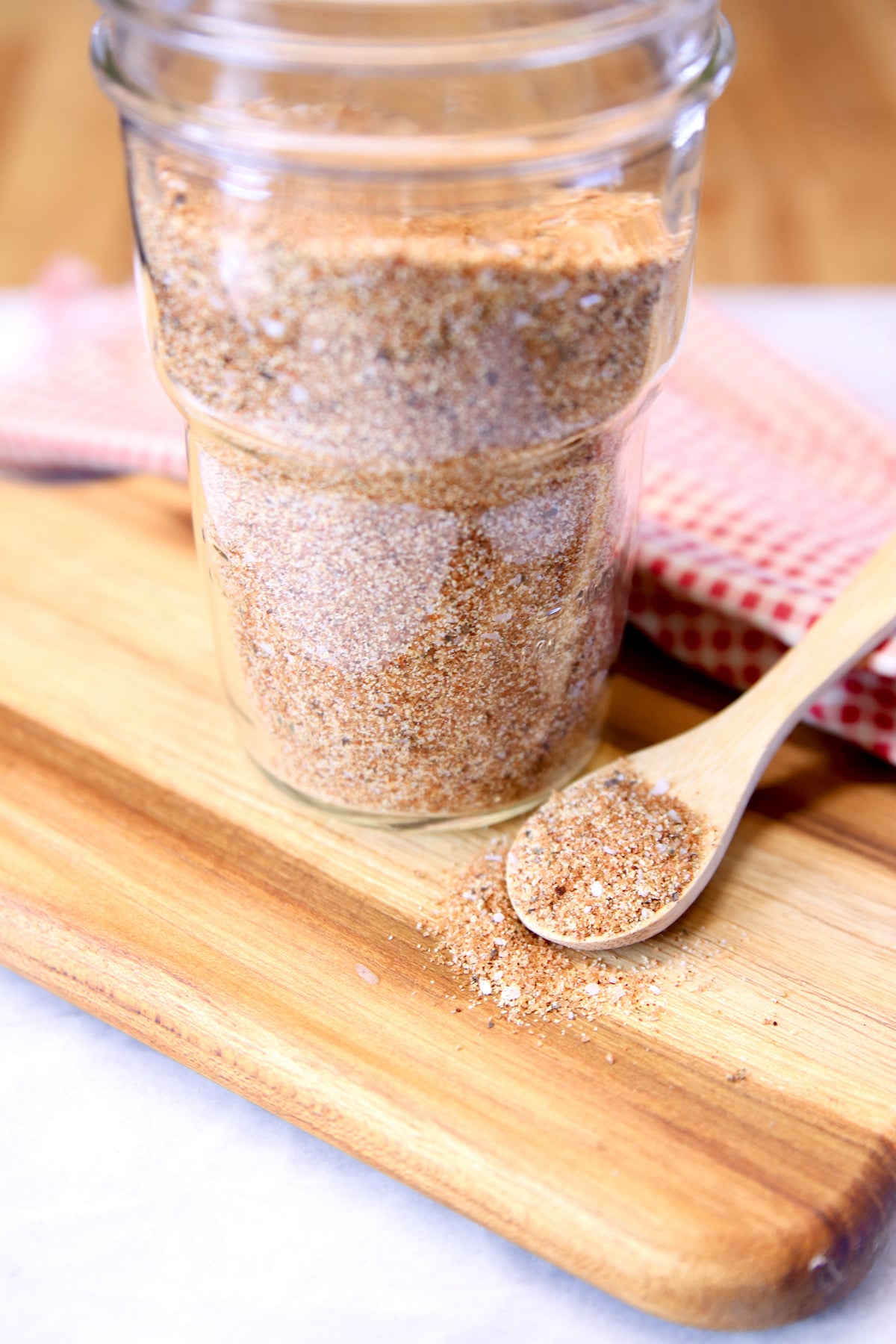 jar of pork rub with spoon of spices.