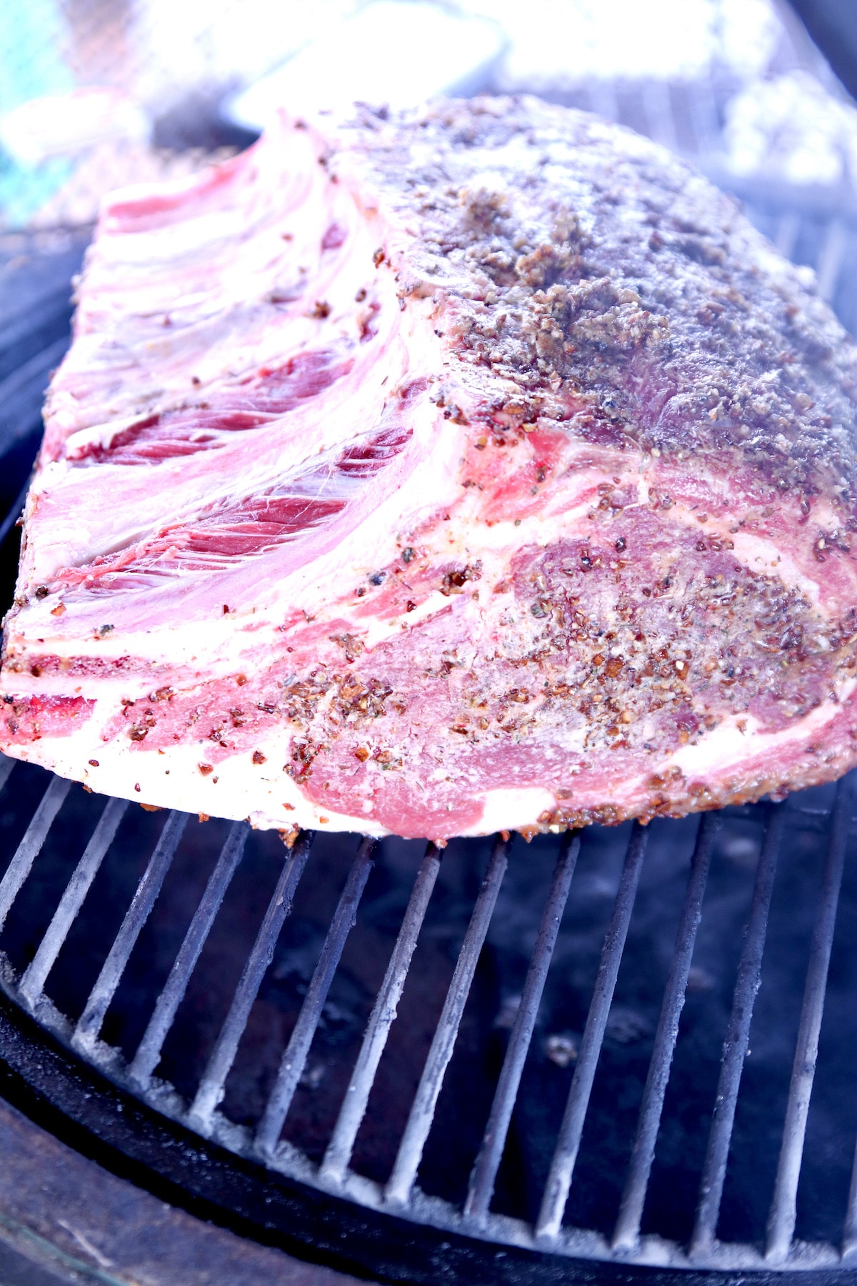 Standing rib roast on a grill.