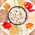 Grilled Salmon Cream Cheese Dip on a platter with vegetables and crackers.
