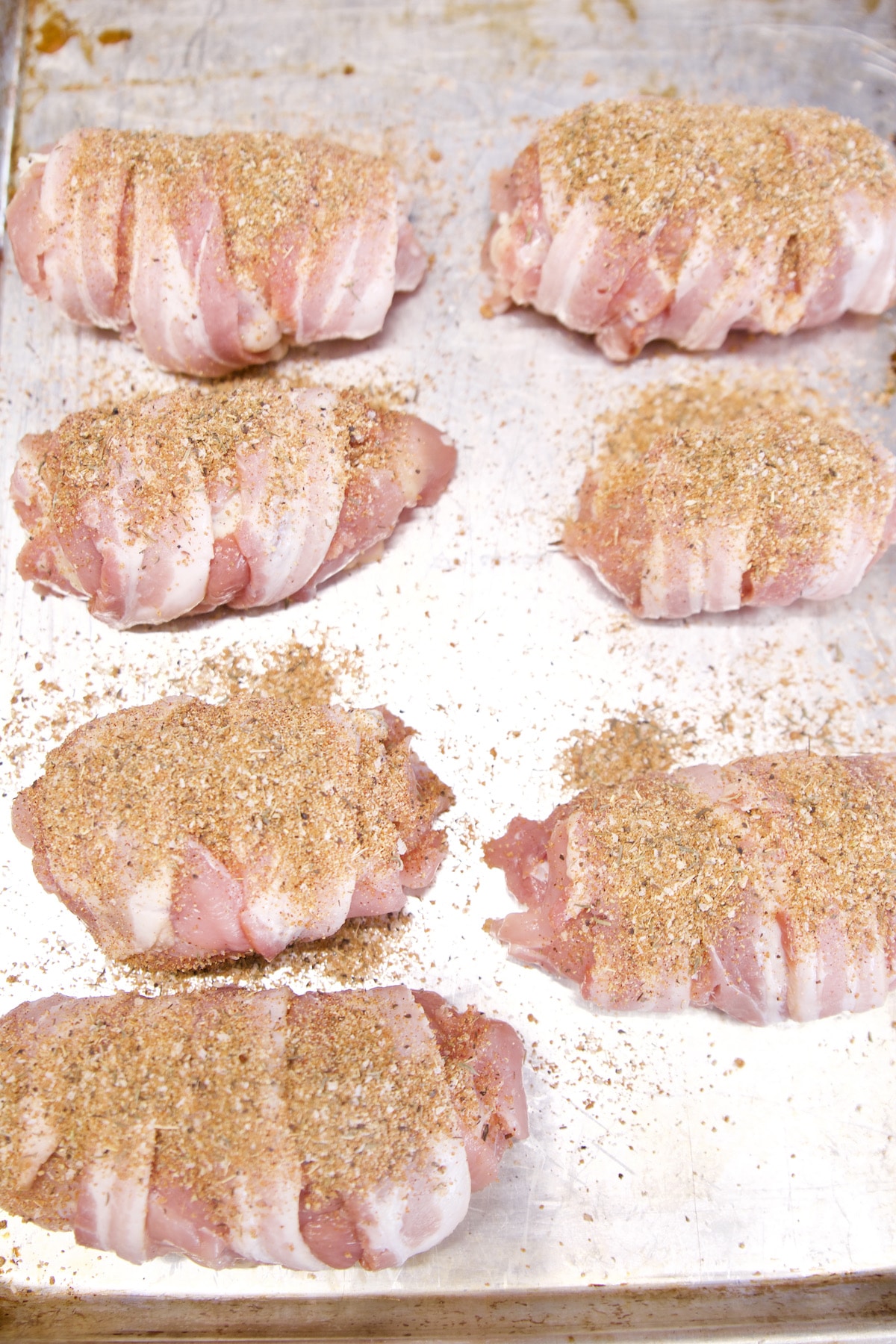 Seasoned bacon wrapped chicken.