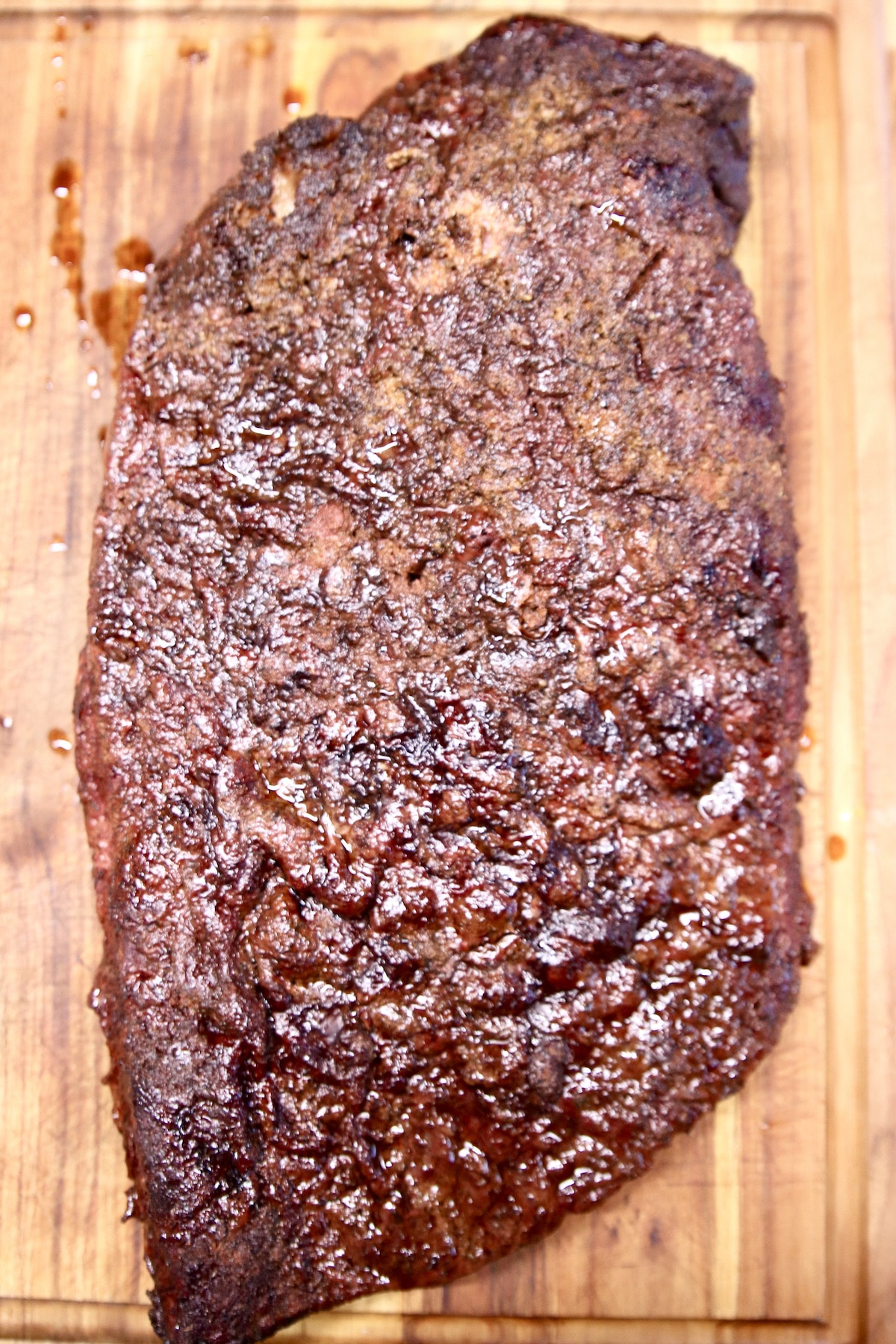 Smoked whole beef brisket on a cutting board.