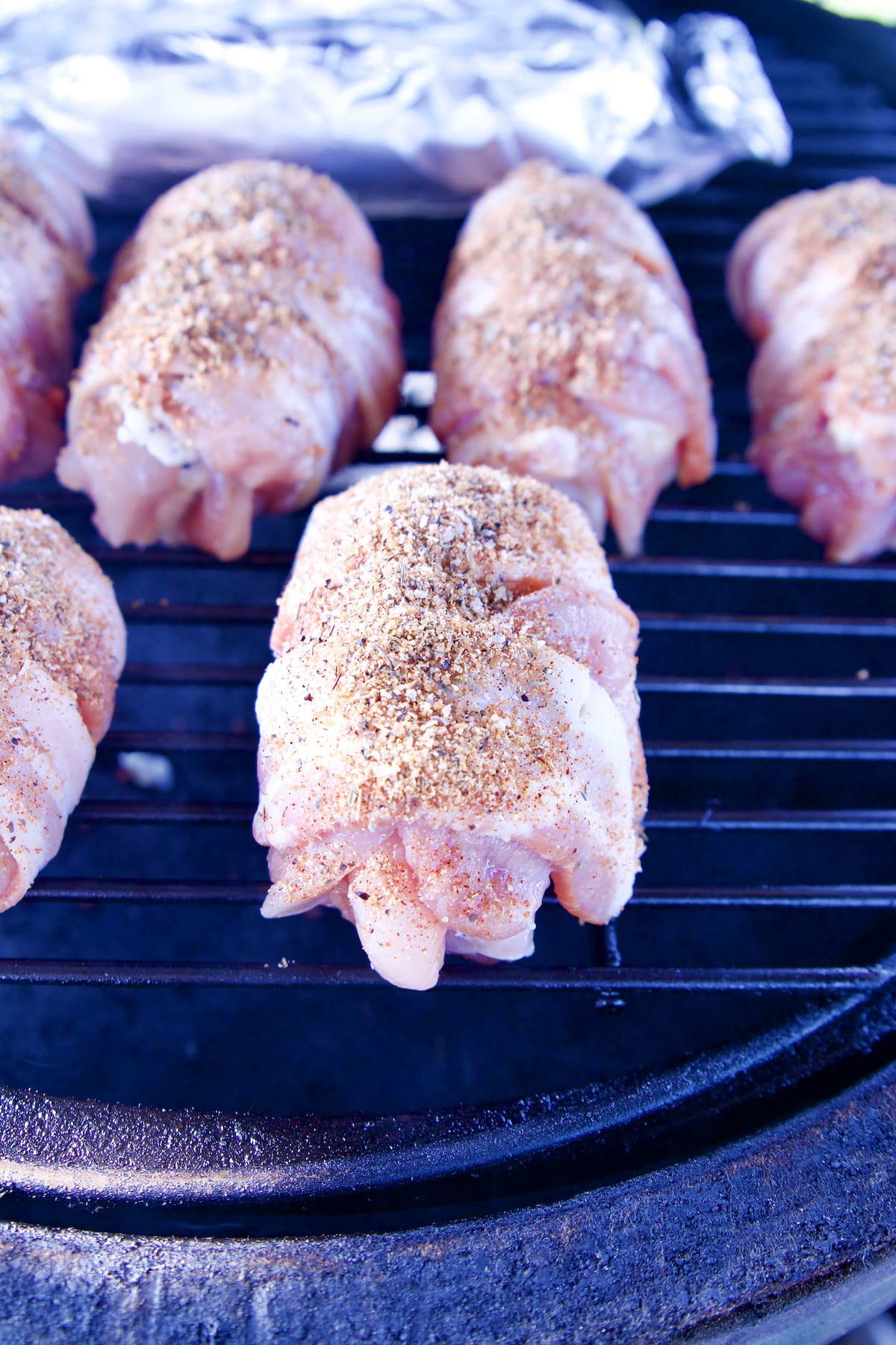 Grilling bacon wrapped chicken.
