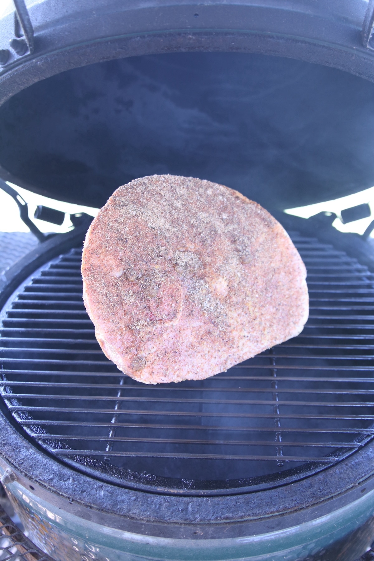 Half ham on a grill.