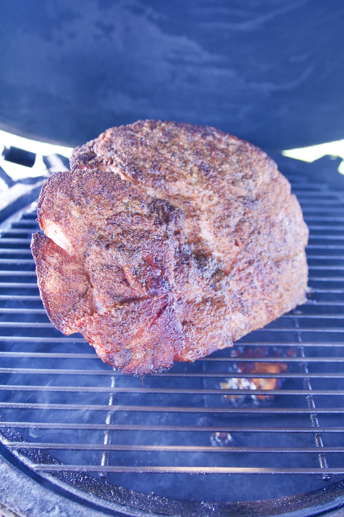 Grilling ham on a big green egg grill.