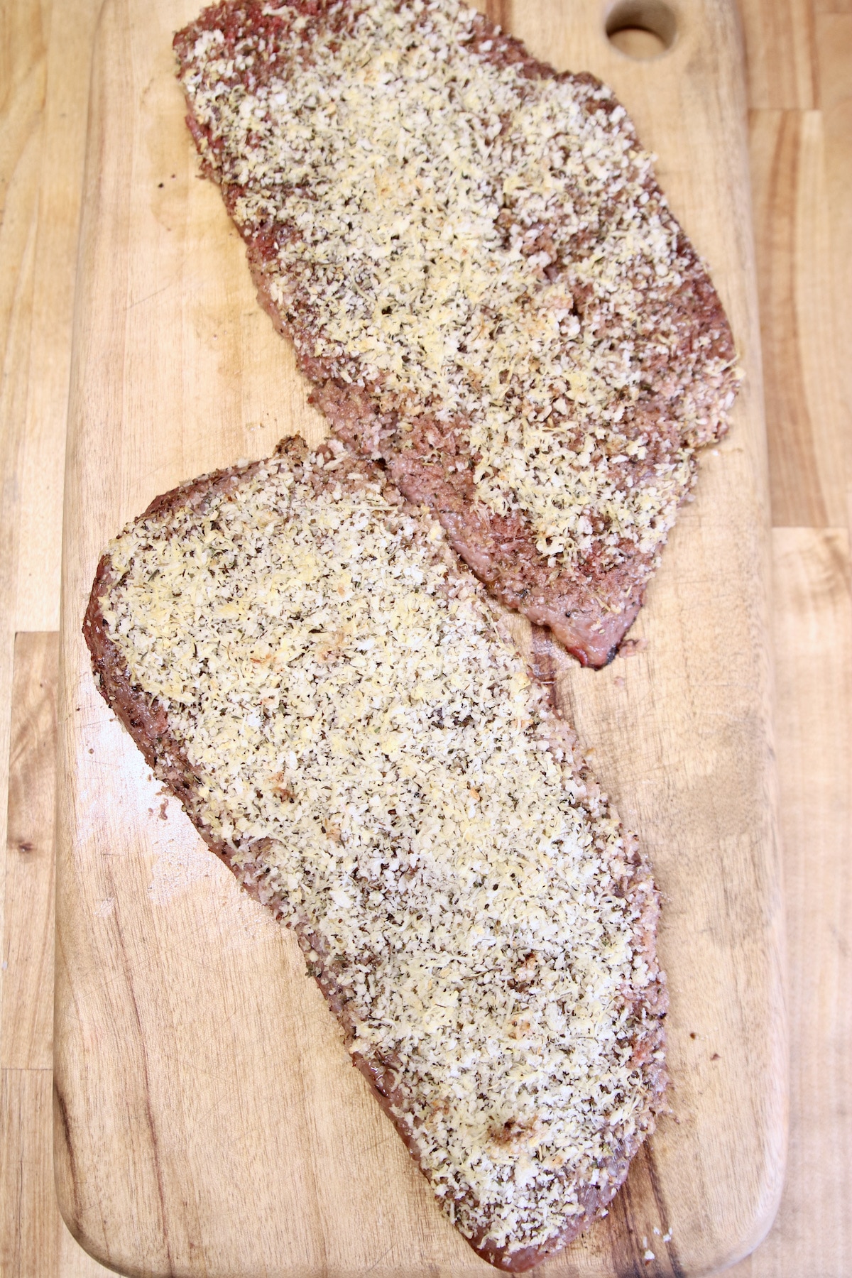 Grilled sirloin steaks resting on cutting board.