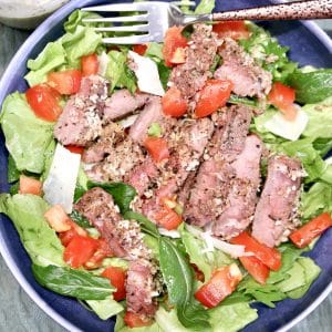Steak Salad in a bowl with tomatoes.