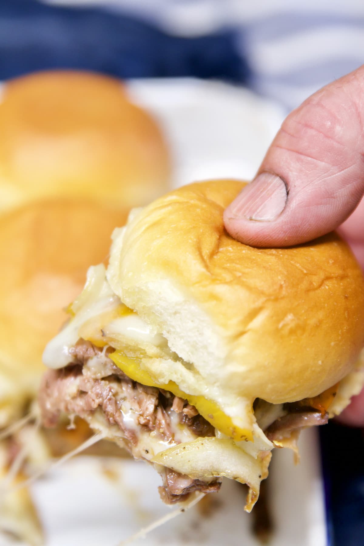 Grilled Philly Cheesesteak Sliders - held in hand.
