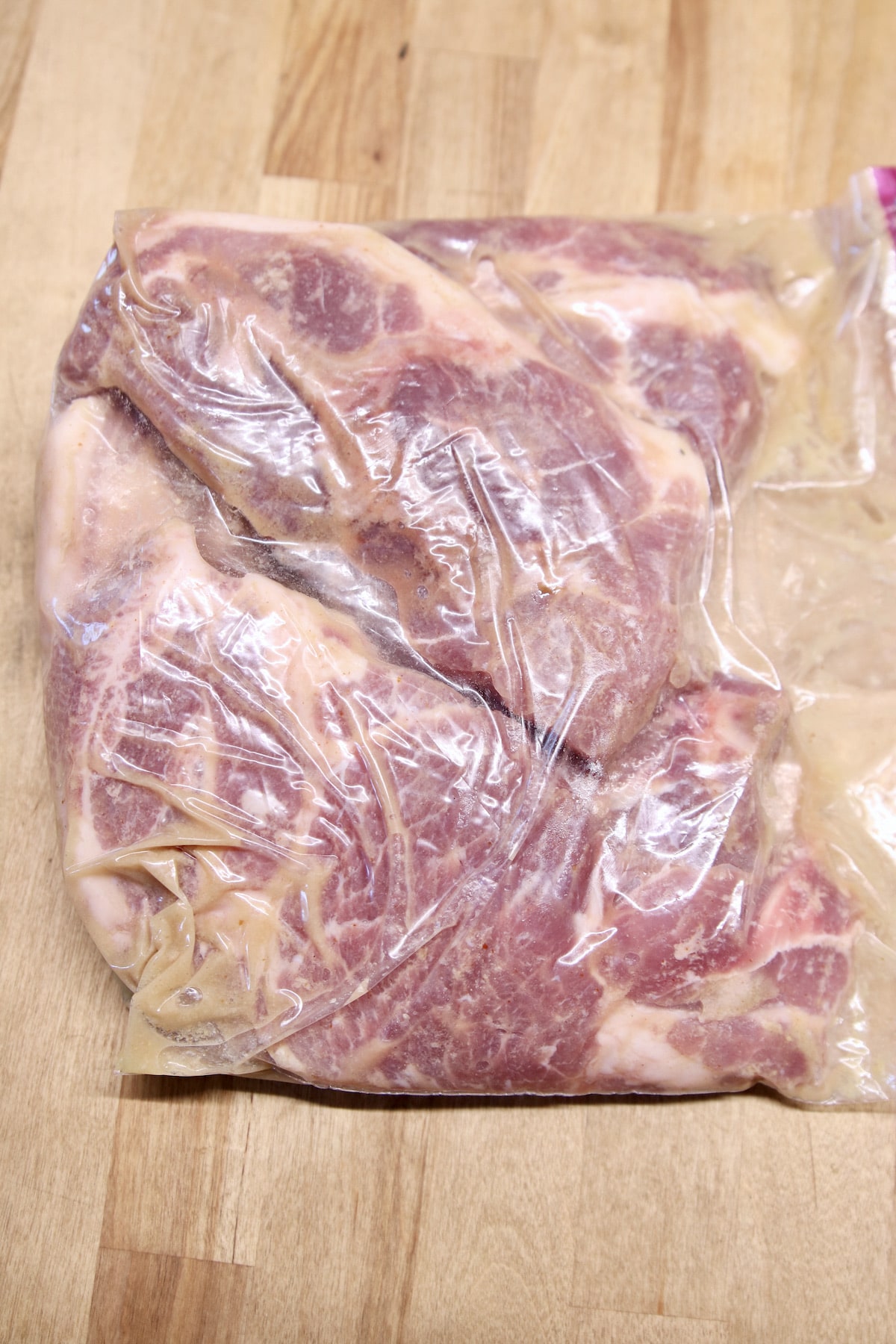Bag of marinating pork steaks.