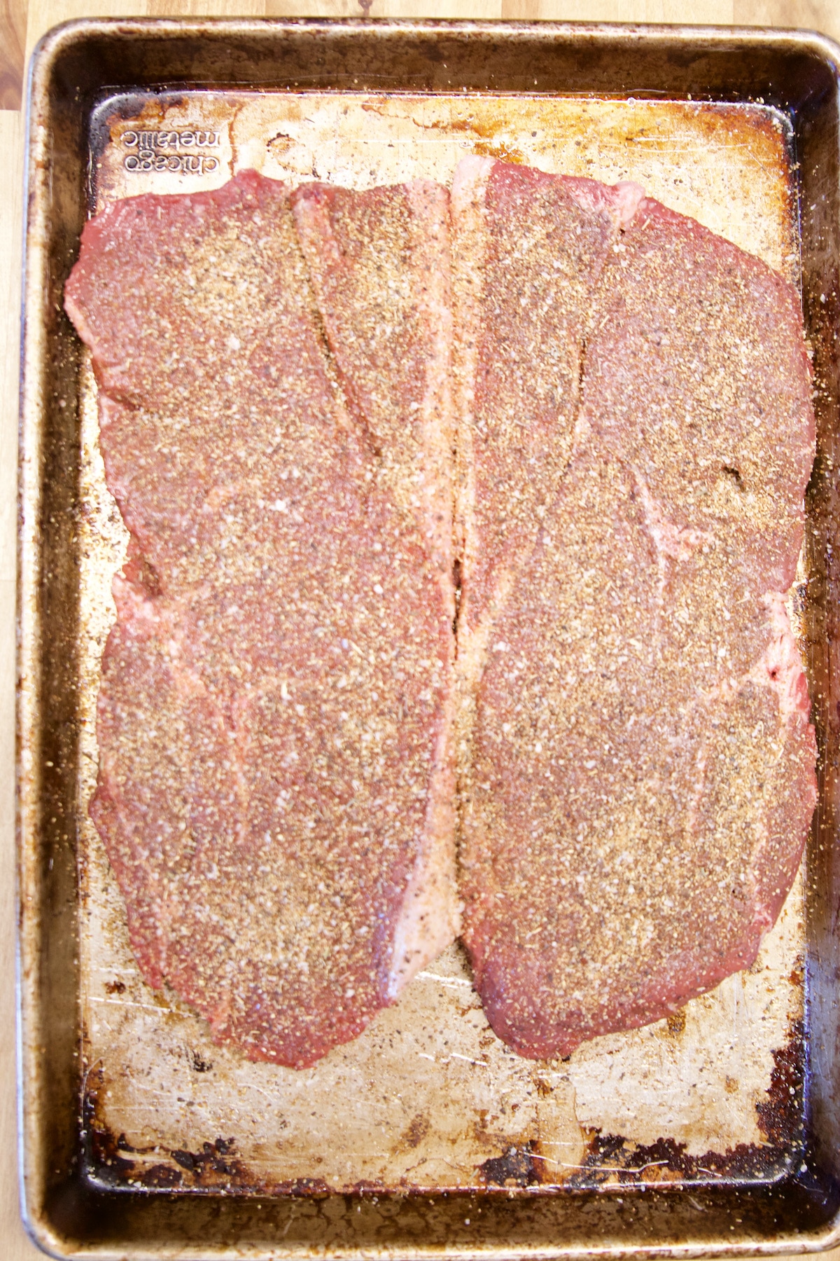 2 Sirloin steaks coated in steak rub.