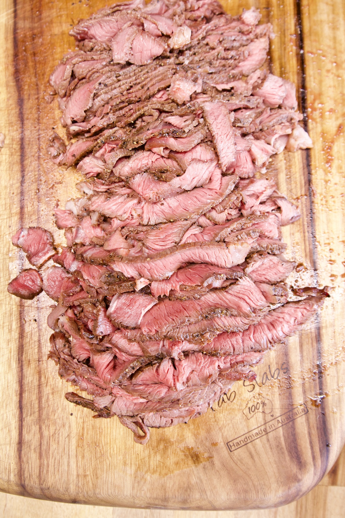 Sliced sirloin steak on a cutting board.