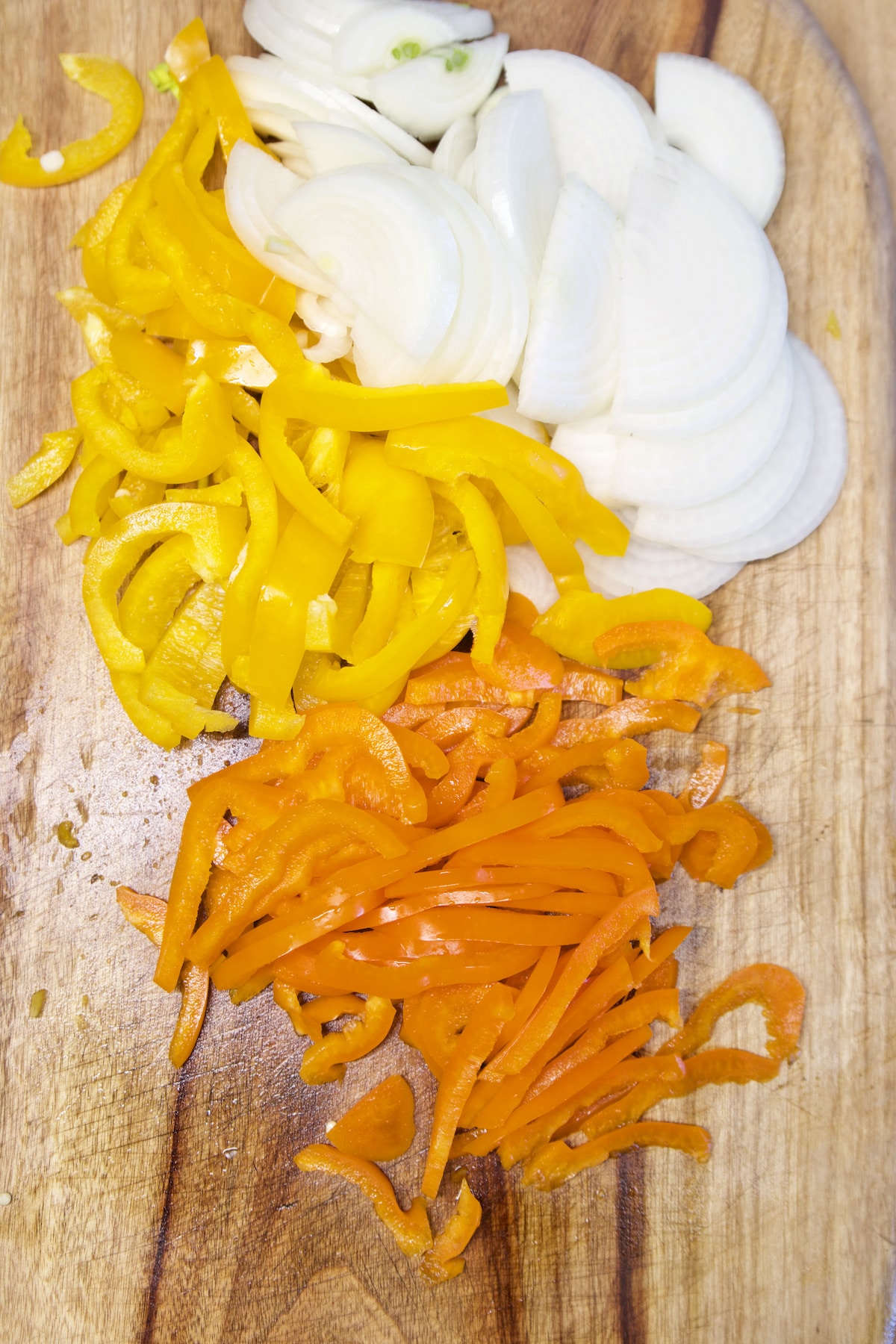 Sliced onions, yellow and orange bell peppers.