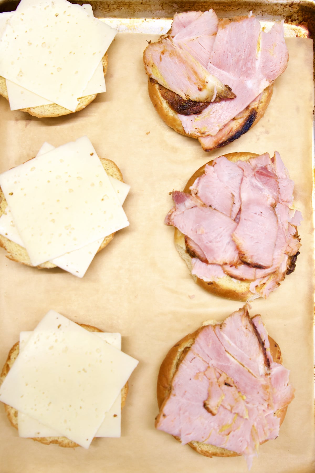Ham and cheese on buns open faced to toast.