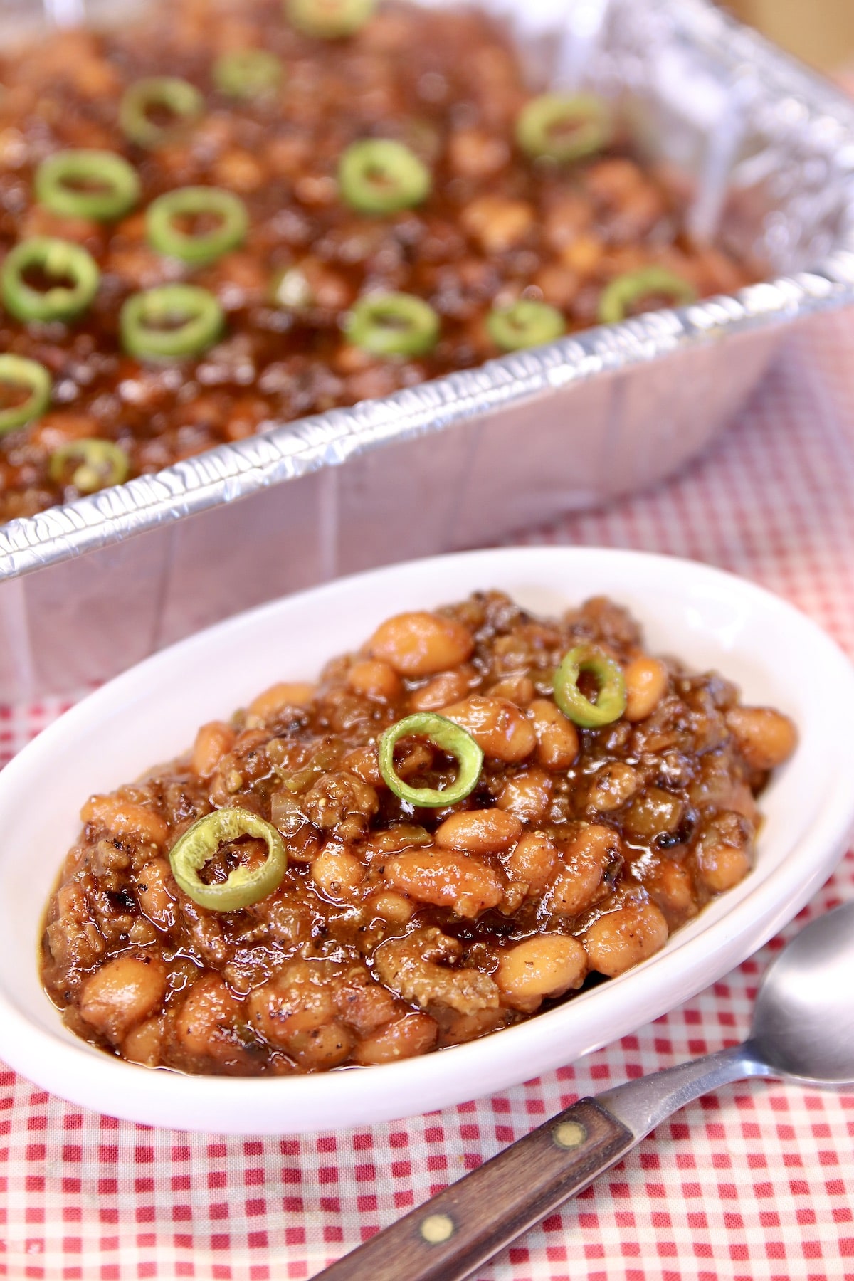 BBQ Cowboy Beans in a dish with pan in background.