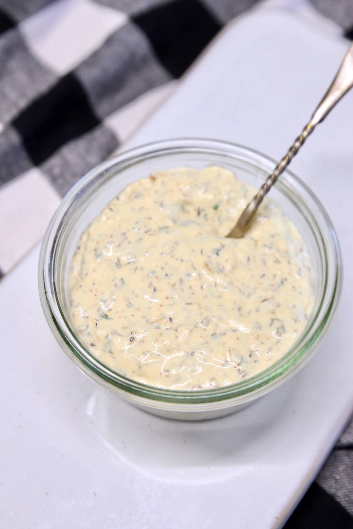 Bowl of garlic cream sauce with a small spoon.